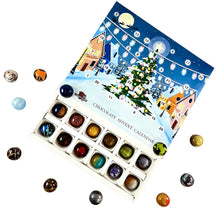 Load image into Gallery viewer, Chocolate advent calendar with a festive design and small chocolates displayed in front.