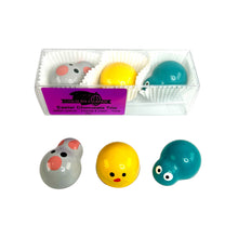 Load image into Gallery viewer, Set of colorful Easter-themed chocolates in a clear container with visible brand name.