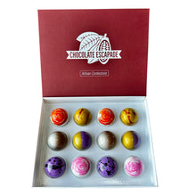 Load image into Gallery viewer, Box of colorful chocolate truffles with 'Chocolate Escapade' branding.