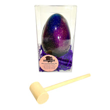 Load image into Gallery viewer, Chocolate Easter egg with a purple and blue gradient in a clear box, accompanied by a wood hammer on a white background.