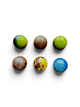 Load image into Gallery viewer, Six small round decorative chocolates arranged in two rows on a white background. The objects have varied colors and patterns, including green, brown, yellow, blue, and marbled finishes.