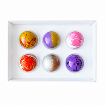 Load image into Gallery viewer, Six colorful chocolates arranged in two rows inside a white rectangular gift box, photographed from above on a white background.
