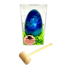 Load image into Gallery viewer, Blue chocolate egg in clear packaging with a wooden mallet on a white background
