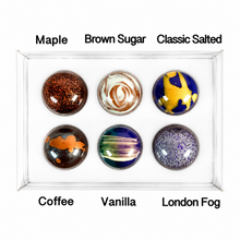 Load image into Gallery viewer, Six round artisanal chocolates labeled Maple, Brown Sugar, Classic Salted, Coffee, Vanilla, and London Fog, arranged in a clear display tray on a white background.

